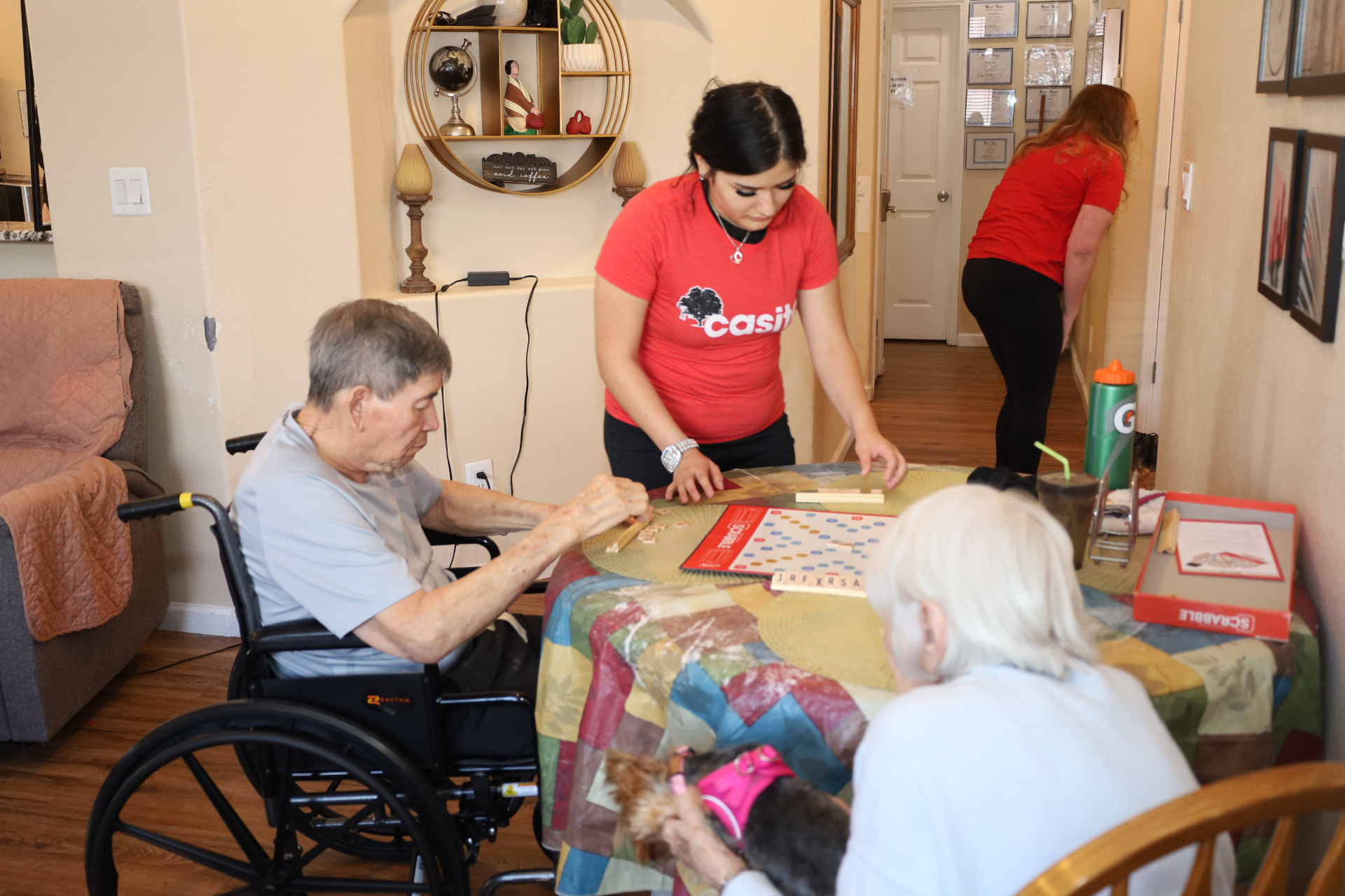 Casita caregiver playing a board game with residents in a cozy living room