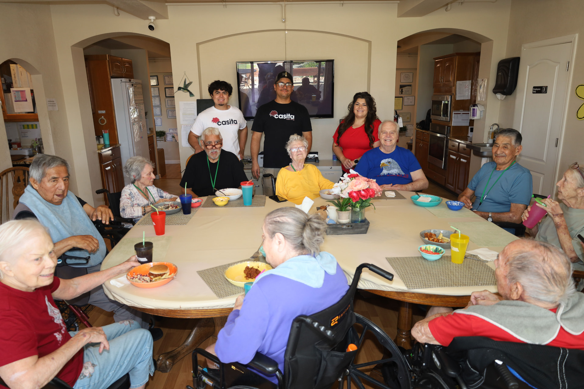 Casita residents and staff gathered around the dining table for a shared meal
