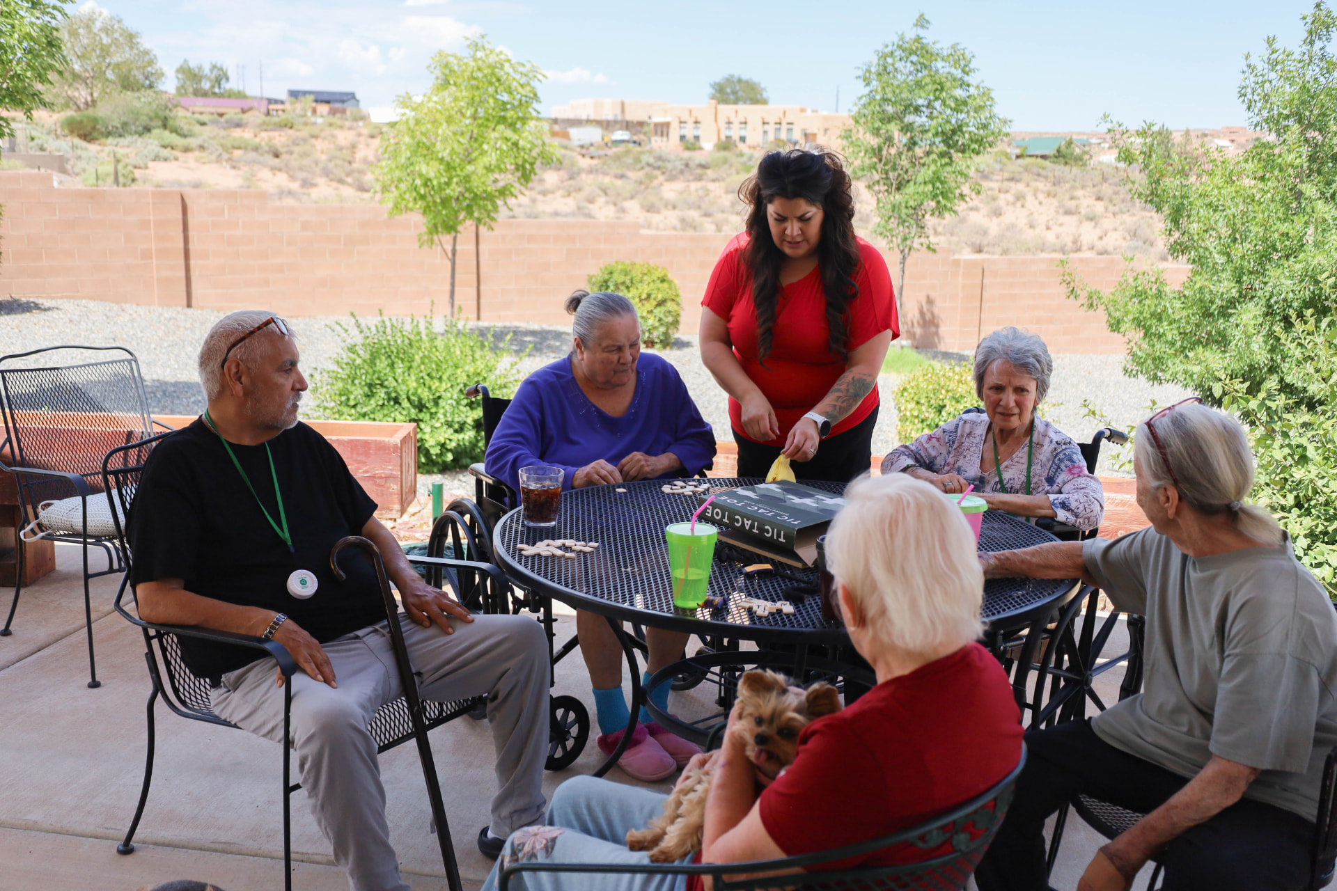 Casita team member playing games with residents on the patio